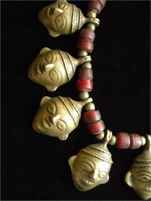 Brass Shrunken Heads on Naga Necklace Close Up